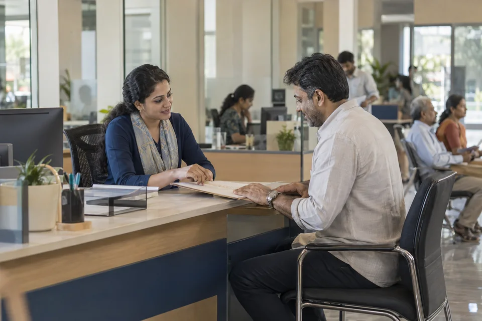 Staff member helping a visitor review a service request at an accessible counter